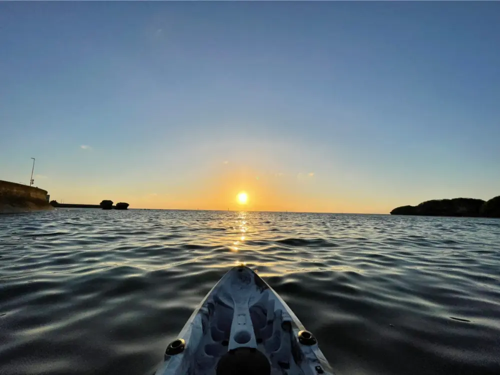 沖縄の夕方に海風を感じながら楽しむサンセット体験の様子